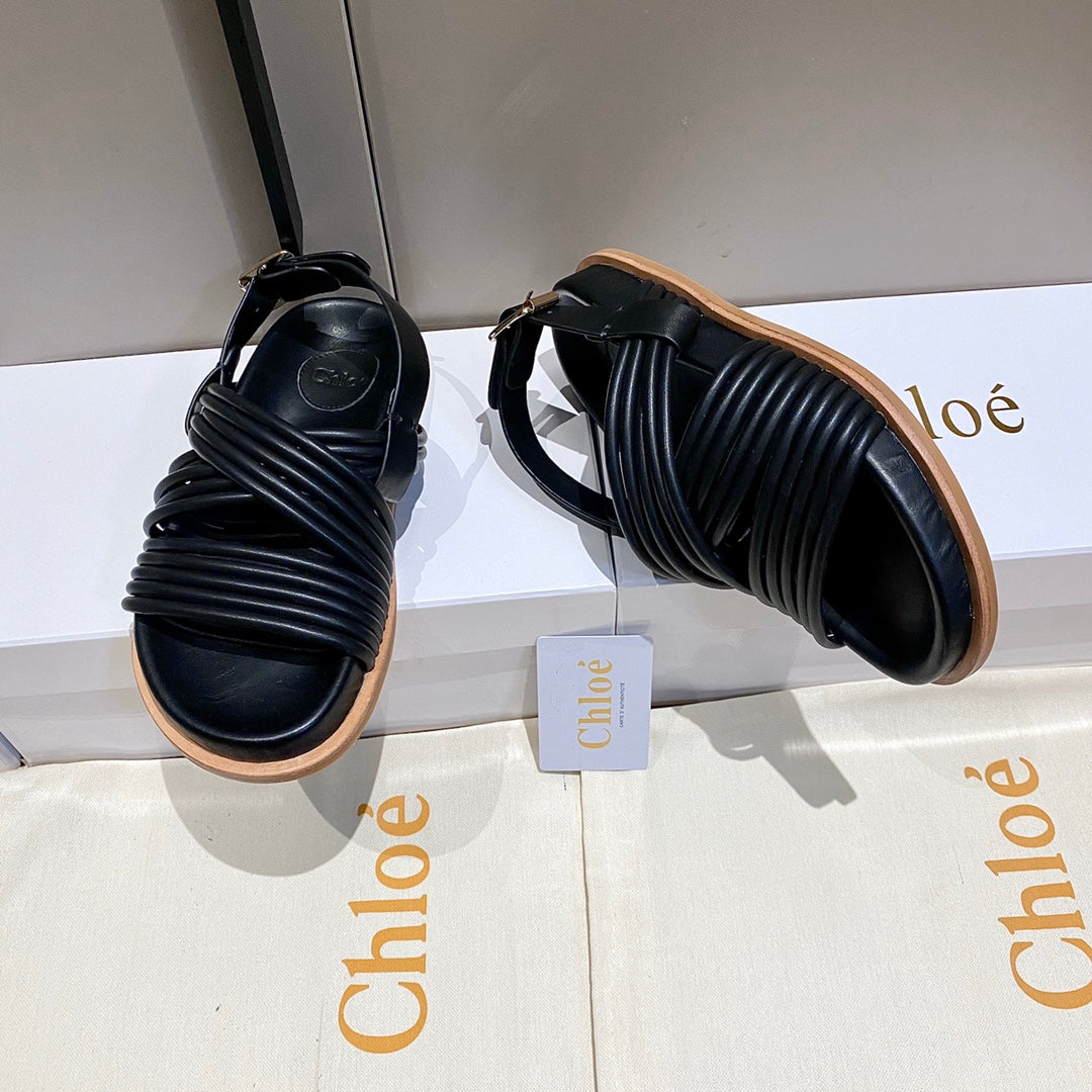 CROSS STRAP SANDAL IN BLACK RUBBER WITH GOLD HARDWARE