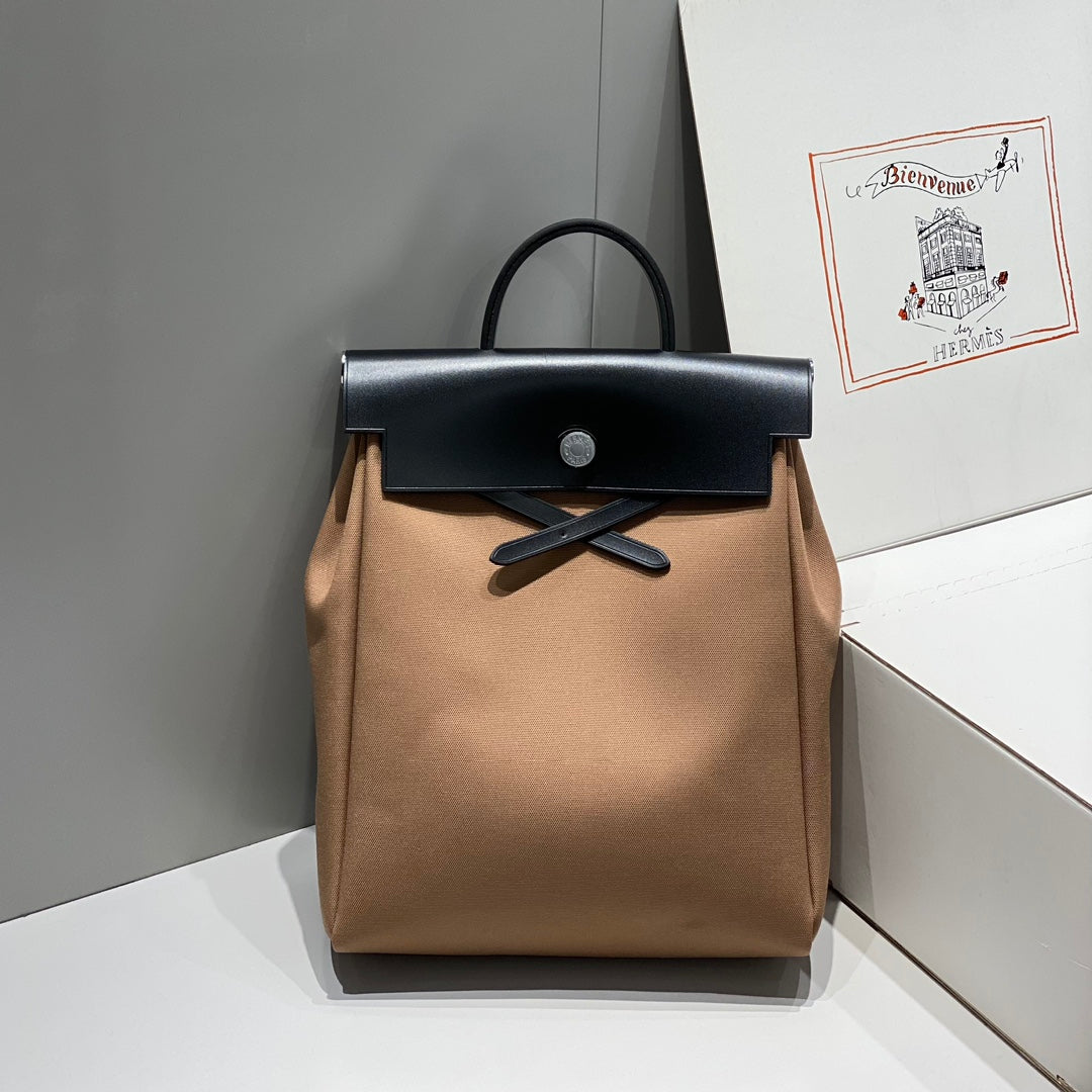 HERBAG A DOS ZIP RETOURNE BACKPACK 29 IN BROWN CANVAS AND BLACK CALFSKIN