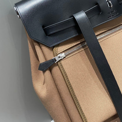 HERBAG A DOS ZIP RETOURNE BACKPACK 29 IN BROWN CANVAS AND BLACK CALFSKIN