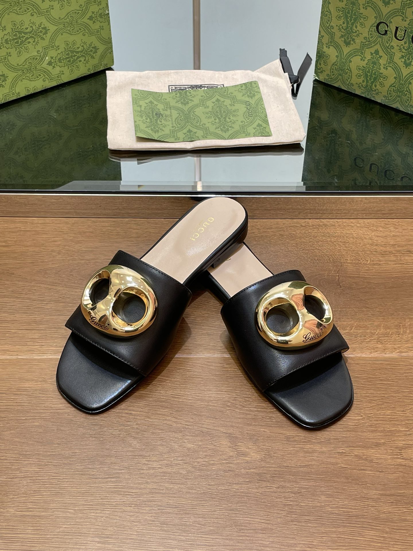 FLAT MULE IN BLACK CALFSKIN WITH GOLD HARDWARE