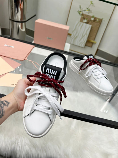 SNEAKER MULES IN BLACK AND WHITE CALFSKIN WHITE RED LACES